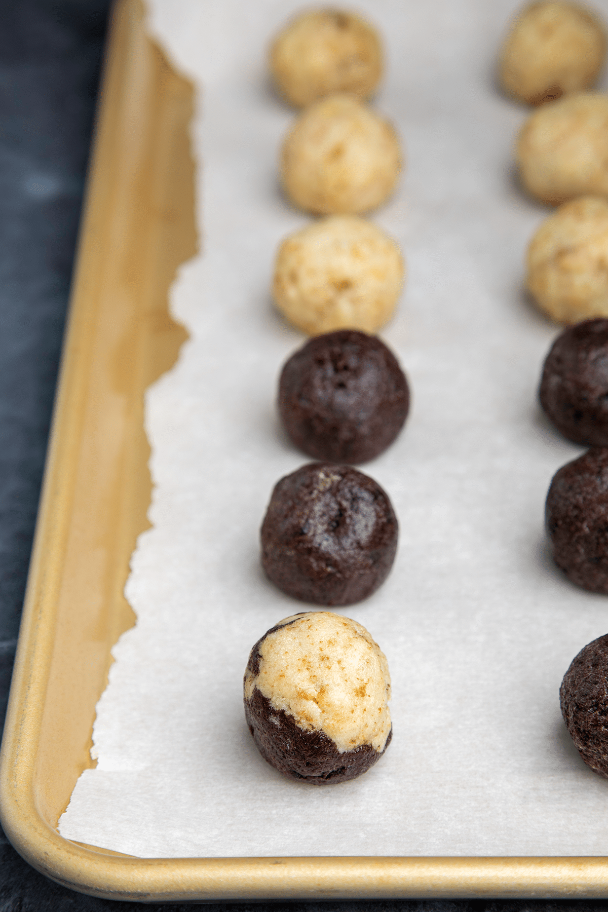 Shaped cake balls without chocolate coating on white paper on tray