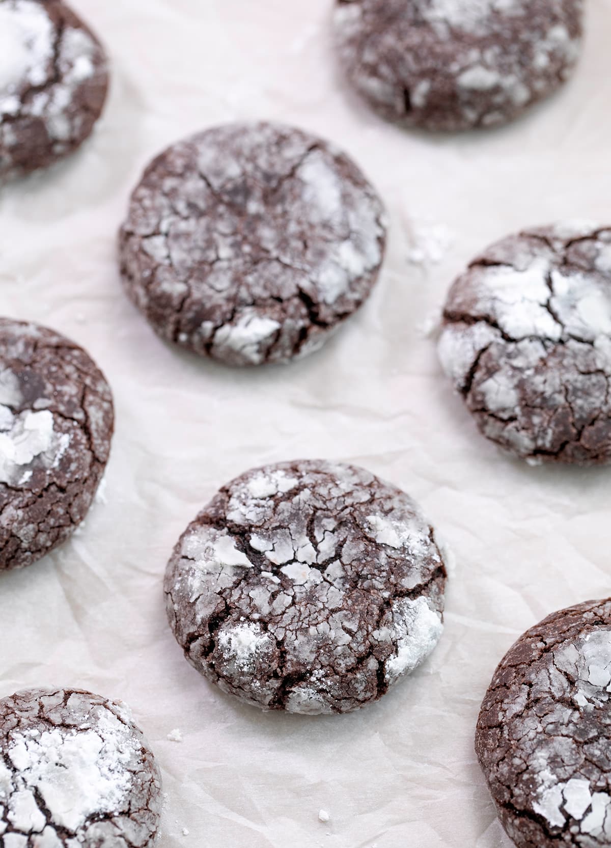 Chocolate crinkle cookies baked on white paper