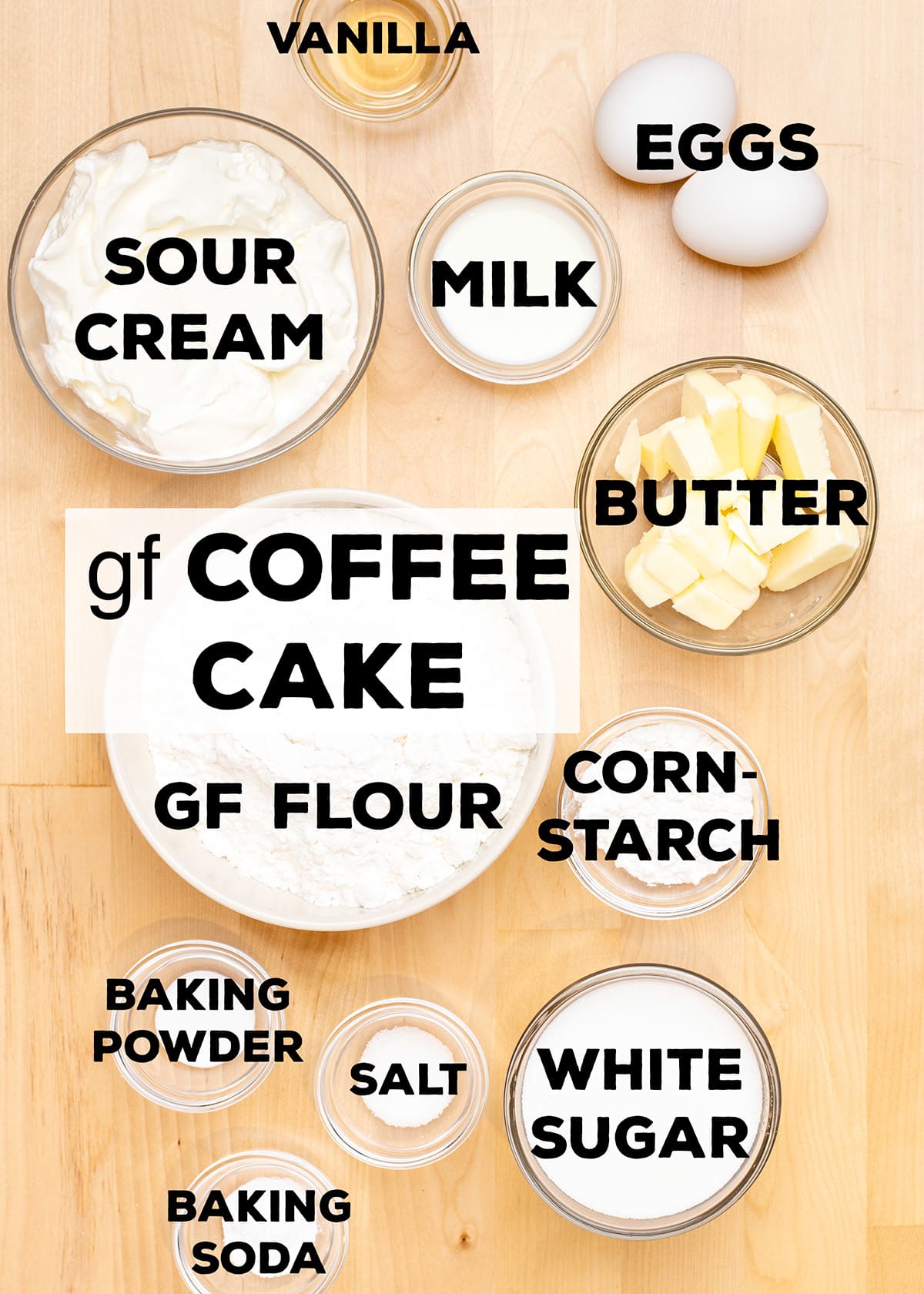ingredients for gluten free coffee cake including sour cream, milk, butter, gf flour, cornstarch, baking powder, salt, baking soda, and sugar in small bowls with words on top