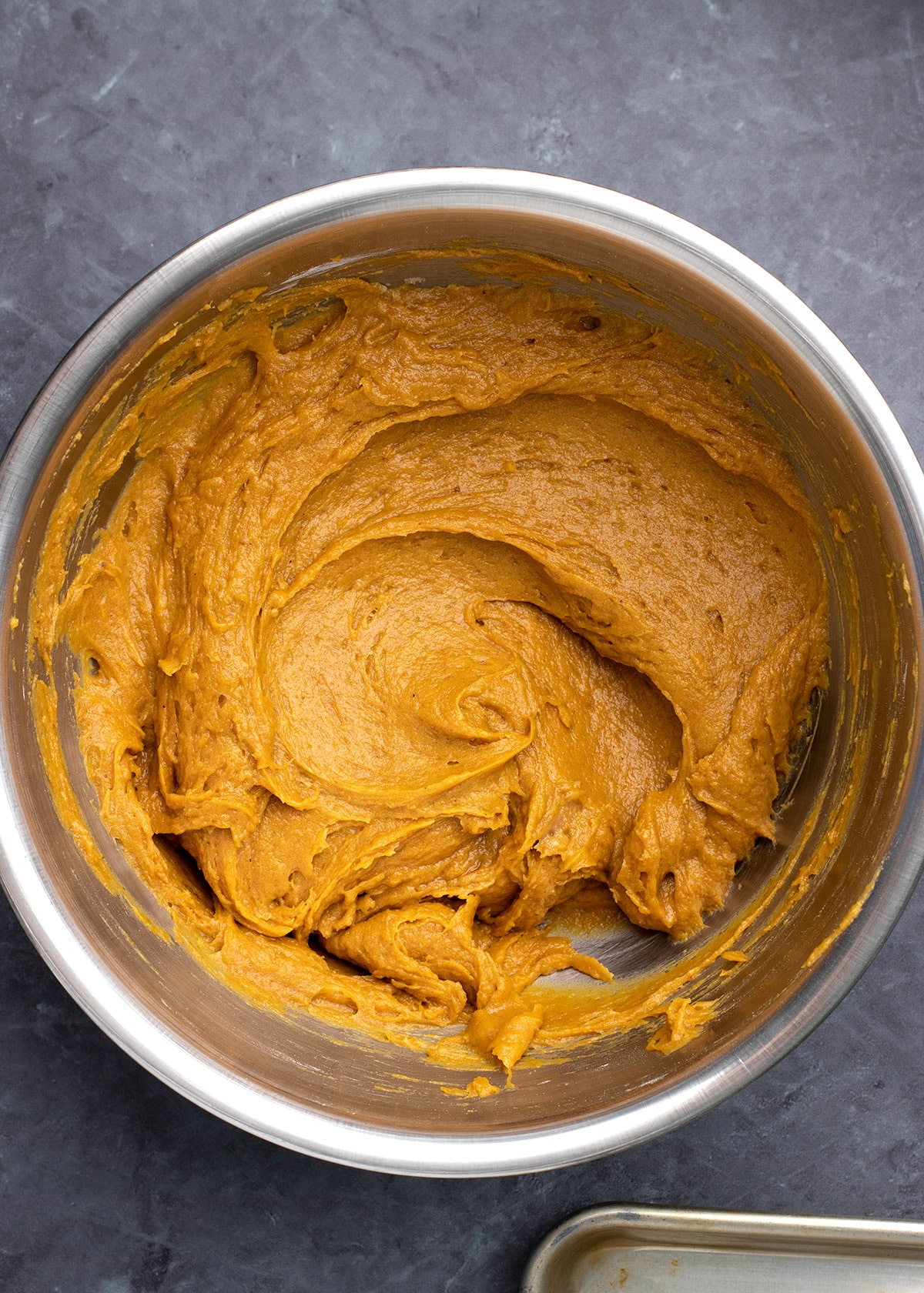 Raw pumpkin bar batter in large round metal bowl