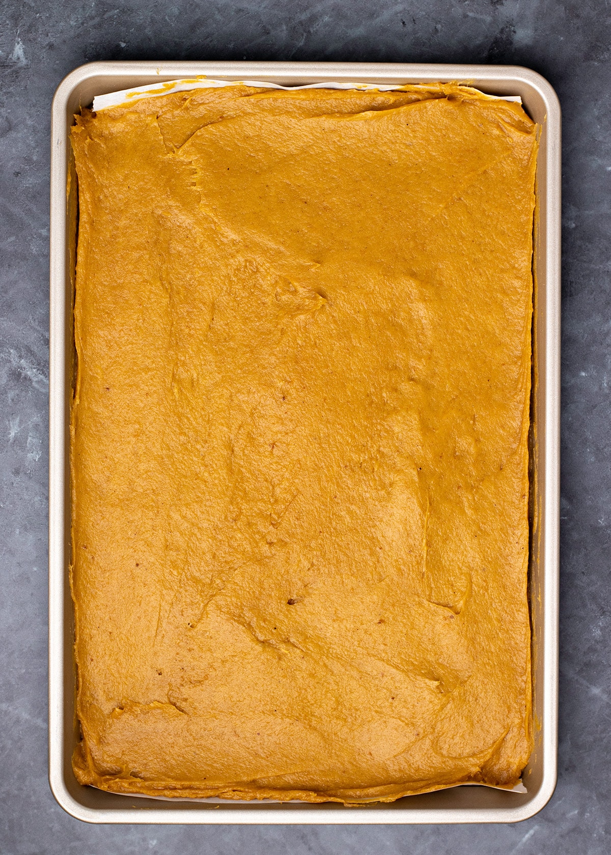 Raw pumpkin bar batter in large round metal bowl